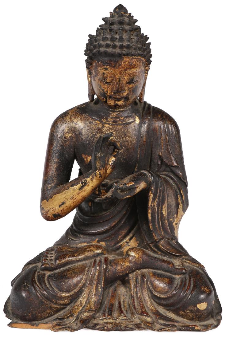 A FINE CHINESE CARVED GILT WOOD BUDDHA, 18TH C: A FINE CHINESE CARVED GILT WOOD BUDDHA, 18TH C. Finely carved in full round of good anatomy and proportions, the robe carved with deep delicate folds and the features finely rendered. Retains a good