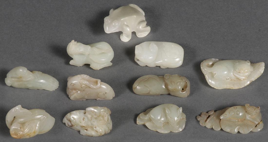 TEN CHINESE CARVED JADE PENDANTS: A GROUP OF TEN CHINESE CARVED JADE PENDANTS, PROBABLY QING DYNASTY. All animal forms or comprising animals including a reclining horse, birds, ram, cat, and others, together with a moon stone carved f