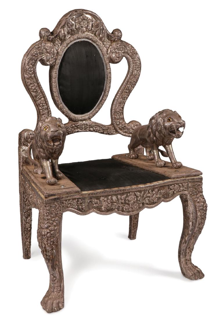 AN INTERESTING LION THRONE CHAIR, PROBABLY INDIA: AN INTERESTING LION THRONE CHAIR, PROBABLY INDIA. The large chair with paw feet at front and prowling lion arm rests with medallion back rest. The wood frame and lions overlaid in repoussé and ch