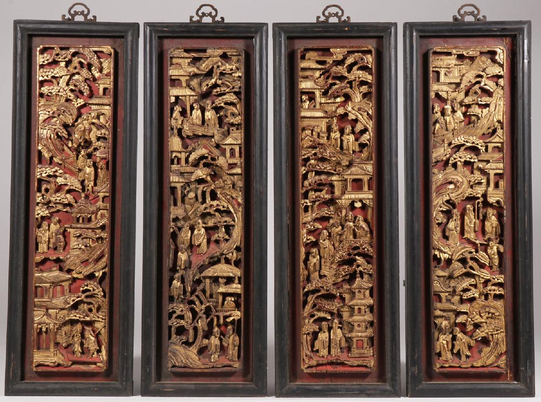 FOUR CHINESE CARVED GILT WOOD PANELS: FOUR CHINESE CARVED GILT WOOD PANELS. Each finely carved in high relief depicting mountainous village scenes with buildings and people and each contained in a matching ebonized wood frame with similar