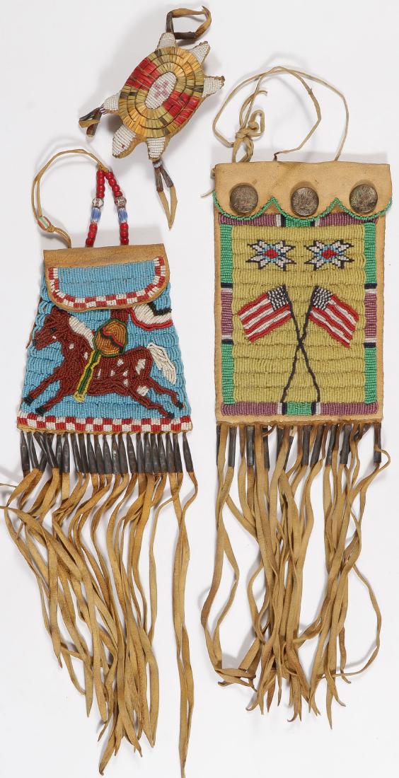 A PAIR OF BEADED BAGS AND EFFIGY: A PAIR OF BEADED BAGS AND EFFIGY. Comprising a sinew-sewn hide beaded turtle effigy with quill-work, shell, and tin cones (some losses), together with two hide lazy stitched beaded bags, the f