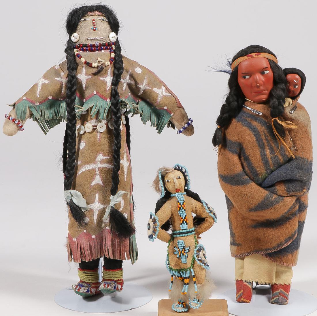 AN INTERESTING BEADED HIDE TWO-FACED DOLL: AN INTERESTING BEADED HIDE TWO-FACED DOLL. The large and imposing figure sinew-sewn with polychrome fringe dress, mother-of-pearl button belt with pony and trade bead drop, beaded legg