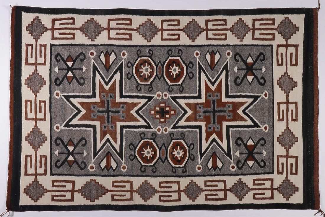 A NAVAJO FOUR CORNERS RUG, CIRCA 1950: A NAVAJO FOUR CORNERS RUG. Woven with natural wool colors and Vallero Stars. 58.5 inches x 39.5 inches. SHIPPING NOTICE: Jackson's is your sole and only source for one stop packing and sh