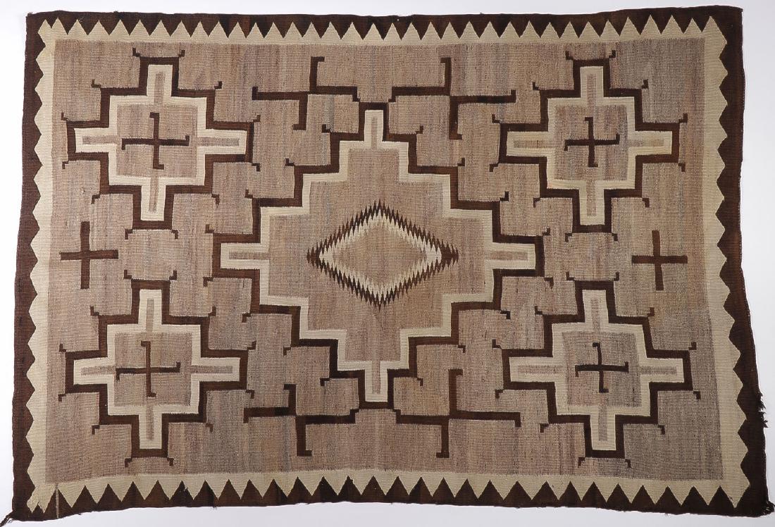 A NAVAJO RUG, CIRCA 1935: A NAVAJO RUG, CIRCA 1935. Woven with cross, diamond, and whirling log patterns and spirit line. 59 inches x 85.5 inches. SHIPPING NOTICE: Jackson's is your sole and only source for one st