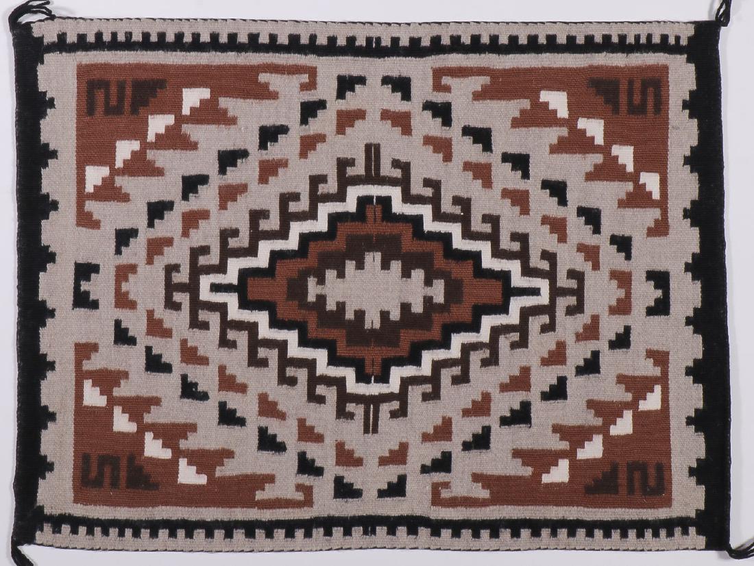 THREE NAVAJO WEAVINGS: THREE NAVAJO WEAVINGS. Comprising a finely woven Two Grey Hills, 18 inches x 23.5 inches, a finely woven storm pattern, 17.5 inches x 23 inches, and a tapestry quality Ganado with spirit line, circa 1