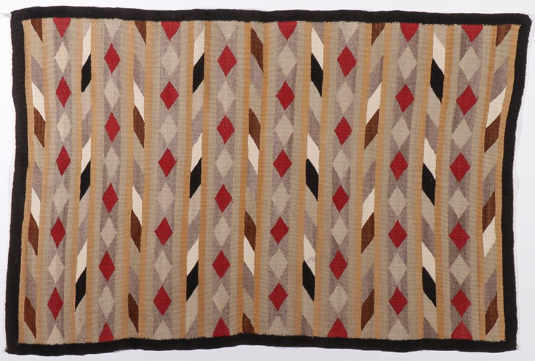 A GROUP OF THREE NAVAJO WEAVINGS: A GROUP OF THREE NAVAJO WEAVINGS. Comprising a finely woven vegetal dye yarn rug of repeating horizontal diamond patterns, circa 1950, size 40 inches x 27 inches, a handspun gallop throw, 39.25 inches