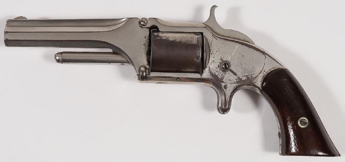A SMITH & WESSON NO. 1 ½ FIRST ISSUE REVOLVER: A SMITH & WESSON NO. 1 ½ FIRST ISSUE REVOLVER. Serial number 7519, caliber .32 rimfire, 5-shot, 3.5-inch barrel, patent dates on top of barrel, rosewood grips, nickel finish (original), worki