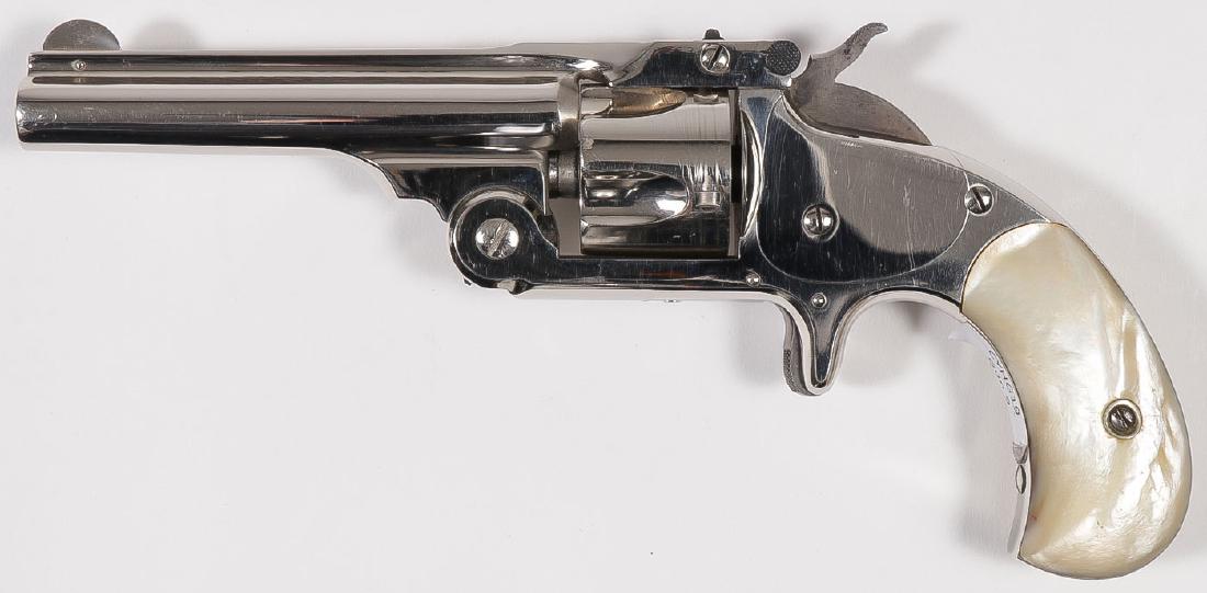 A SMITH & WESSON NO. 1 ½ SINGLE ACTION REVOLVER: A SMITH & WESSON NO. 1 ½ SINGLE ACTION REVOLVER. Serial number 27448, caliber .32 S & W, 5-shot, 3.5-inch barrel, patent dates on top of barrel, mother-of- pearl grips, nickel finish 