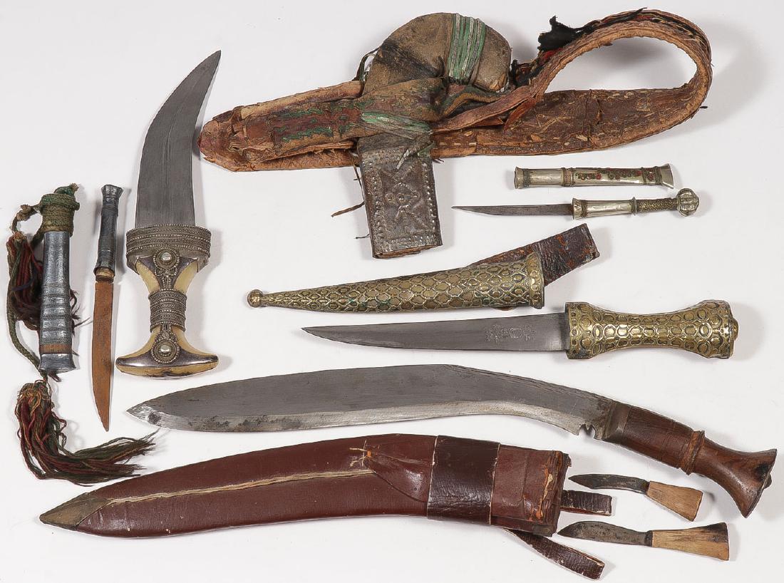 FIVE DAGGERS/KNIVES: FIVE DAGGERS/KNIVES. Comprising five various hand held edged weapons including a Jambiyah with sheath and belt, a large Gurkha with leather sheath, together with three other sheathed knives of various
