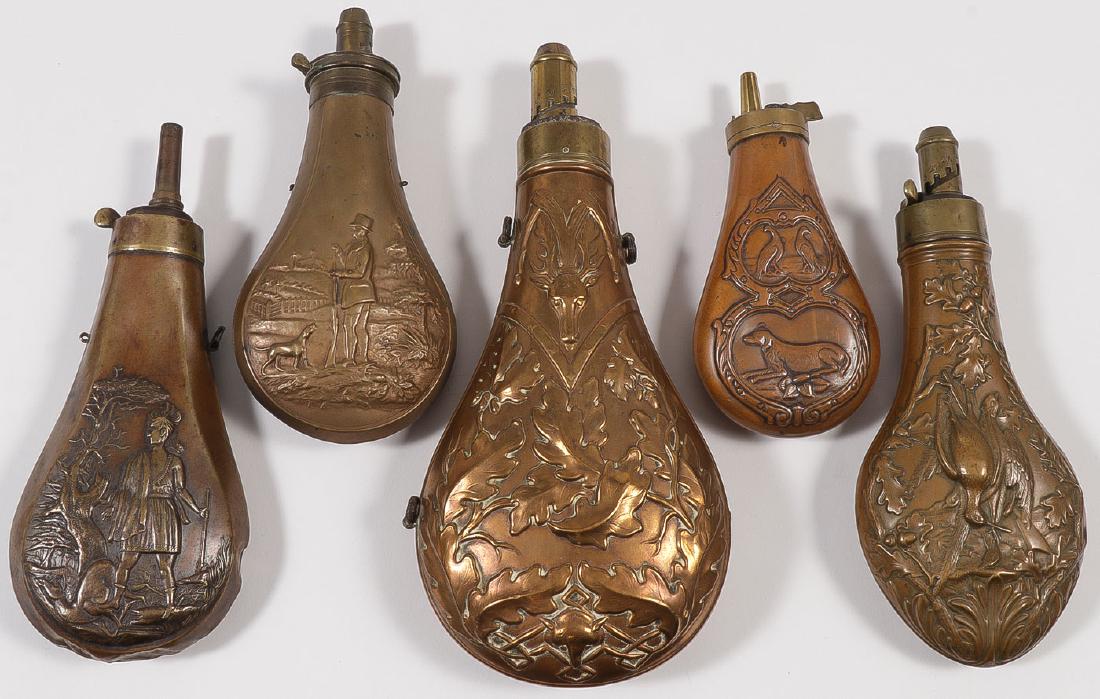 A GOOD GROUP OF FIVE POWDER FLASKS, 19TH C: A GOOD GROUP OF FIVE POWDER FLASKS, 19TH C. Comprising a large and impressive Hawksley marked example of traditional form with embossed oak leaves, stag head at top and fox head at base, height 9.75 i