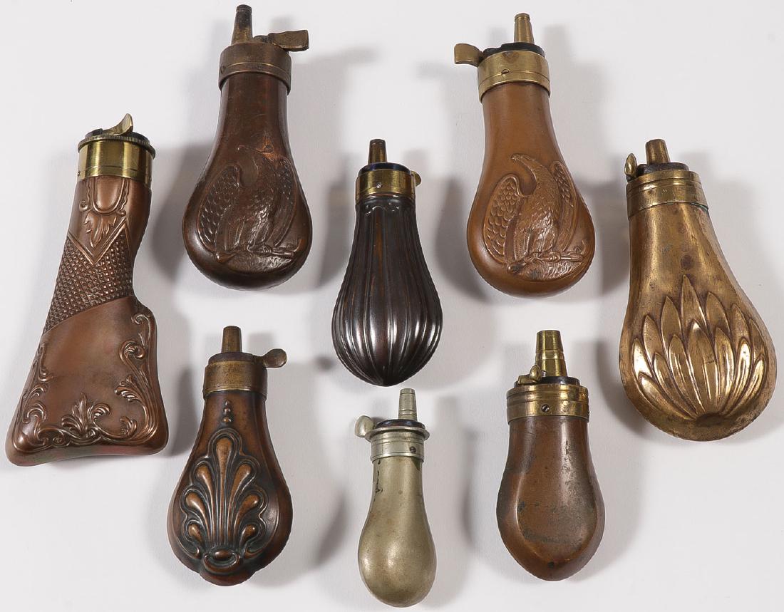 GROUP OF EIGHT POWDER FLASKS: GROUP OF EIGHT POWDER FLASKS. Comprising eight copper and/or brass powder flasks circa 19th and 20th century including some reproductions, of traditional shape and form, two with Federal Eagles, one g