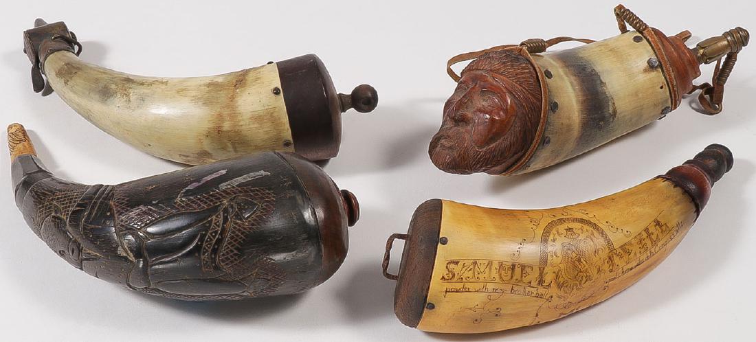 FOUR HORN POWDER FLASKS: FOUR HORN POWDER FLASKS. Comprising four powder flasks, each with horn bodies, one scrimshawed with coat of arms, a name, a motto, and the verso with a churchyard cemetery scene, and carved wood nippl