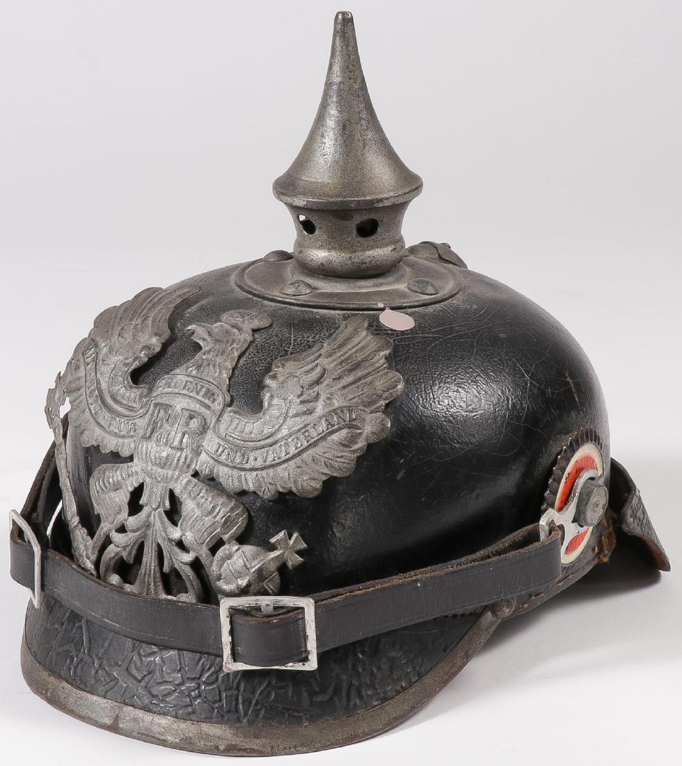GERMAN WWI SPIKED HELMET: GERMAN WWI SPIKED HELMET. A German Model 1915 Pickelhaube spiked helmet in black leather with original cockades and Prussian eagle plate and removable spike. SHIPPING NOTICE: Jackson's is