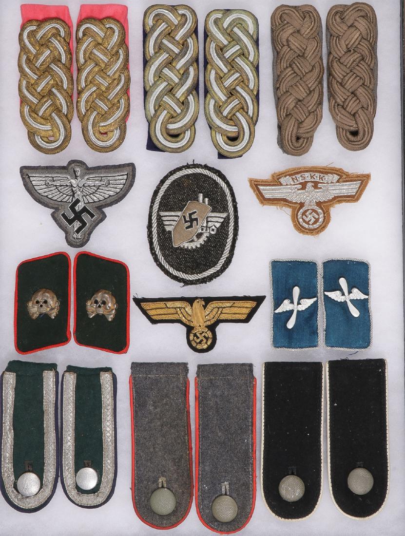 GERMAN WWII INSIGNIA: GERMAN WWII INSIGNIA. Comprising a group of cloth and embroidered items including six sets of epaulettes, a pair of panzer collar tabs, verso with paper label for Karl Gieder Wien, a pair of DLV colla