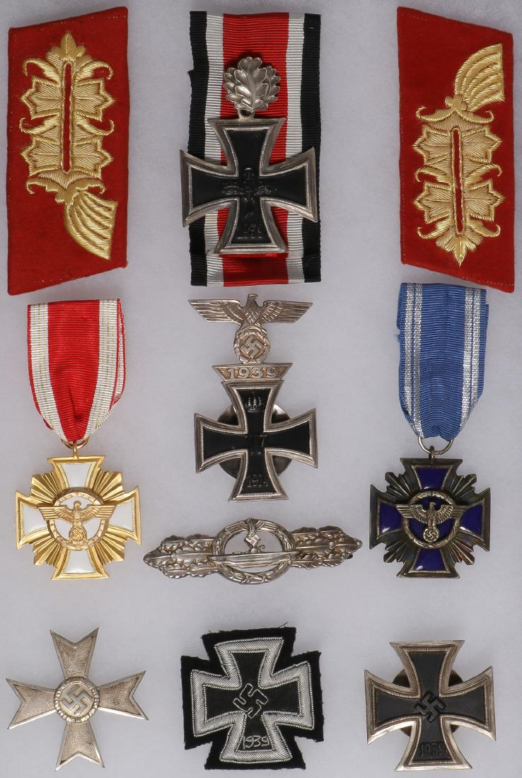 GERMAN WWII STYLE MEDALS: GERMAN WWII STYLE MEDALS. A group of German WWII replica insignia including a Knight's Cross, General collar tabs, a 1914 iron cross first class with attached 1939 clasp, gold and silver NSDAP lon