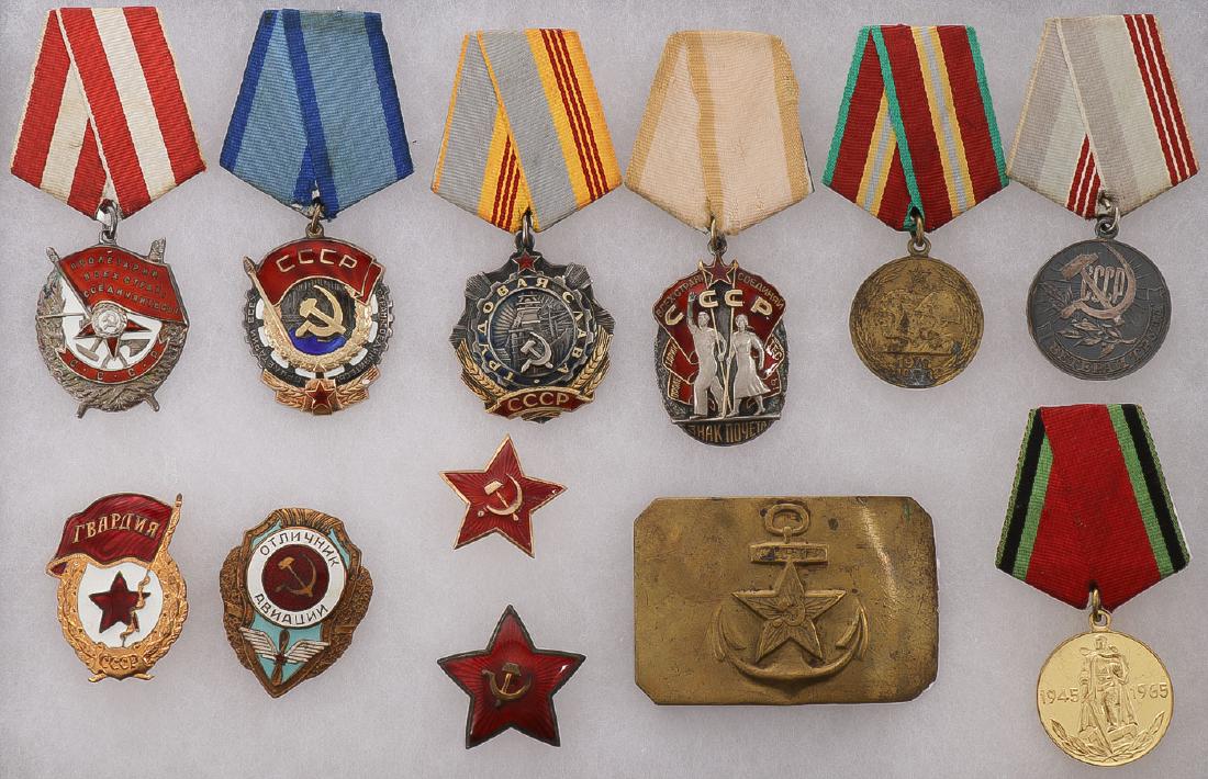 A GROUP OF SOVIET RUSSIAN MEDALS: A GROUP OF SOVIET RUSSIAN MEDALS. Comprising 12 Soviet Russian military items, mostly medals and badges, including the Order of the Red Banner (Military), verso engraved with issuance number 239888 an