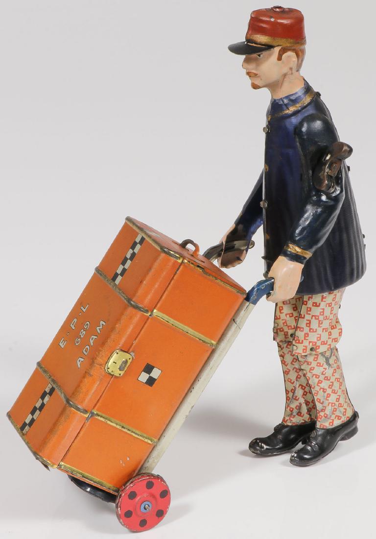 A GOOD LEHMANN TIN WIND-UP PORTER: A GOOD LEHMANN TIN WIND-UP PORTER. Comprising a very good example retaining the majority of original finish with trunk. Fully functional. Height 8 inches. Provenance: From the lifetime collectio