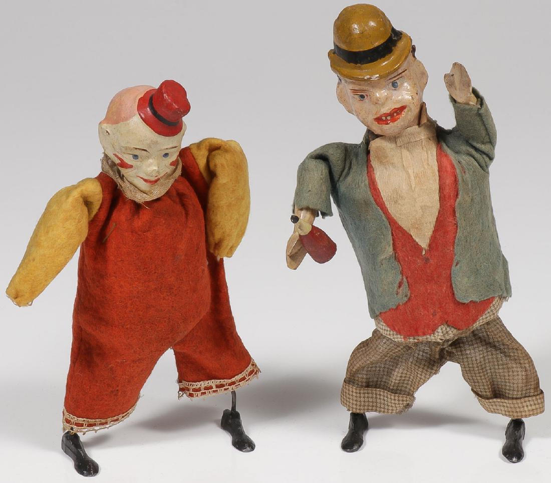 PAIR OF EARLY GERMAN CLOCKWORK WALKERS: PAIR OF EARLY GERMAN CLOCKWORK WALKERS. Comprising a town drunk and clown. Both with painted composition heads, felt clothing, wire legs, and metal feet. Clockwork mechanism when wound produces wobbli