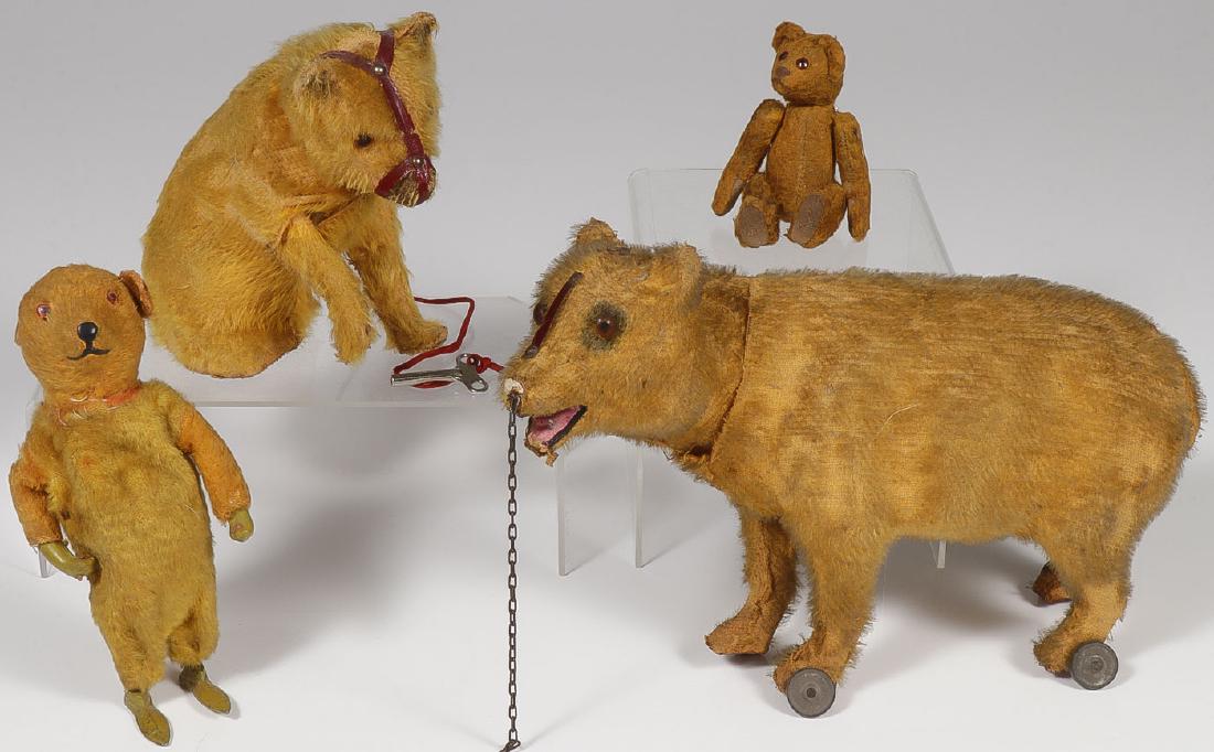 EARLY GERMAN MECHANICAL MOHAIR BEARS & MORE: EARLY GERMAN MECHANICAL MOHAIR BEARS & MORE. Comprising an upright wind-up walking bear with die cast feet, glass eyes and composition hands (works), height 6.75 inches, a seated wind-up bear 