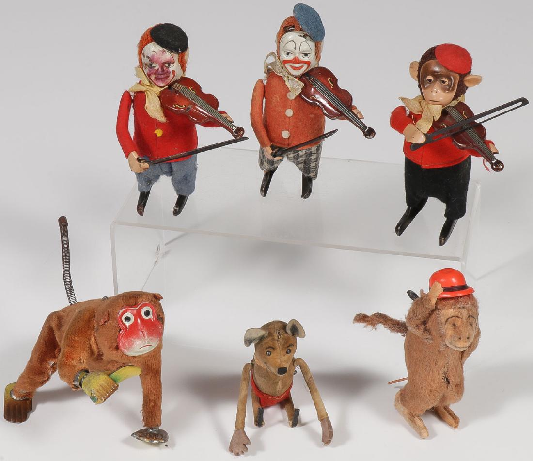 A GROUP OF SIX VINTAGE WIND-UPS: A GROUP OF SIX VINTAGE WIND-UPS. Comprising three Schuco key wind "Solisto" clowns playing violin, and a similar monkey violinist, a velveteen body key wind character flipping mouse, an A