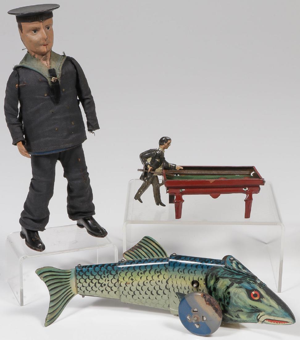 VINTAGE GERMAN TIN TOYS: VINTAGE GERMAN TIN TOYS. Comprising a Lehmann dancing sailor, takes wind and functions but missing left arm. Together with a key wind tin litho fish that undulates forward when wound (length 8.5 inche