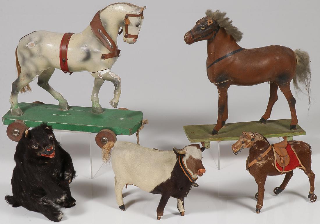 FIVE EARLY WOOD AND PAPIER-MACHE ANIMAL TOYS: FIVE EARLY WOOD AND PAPIER-MACHE ANIMAL TOYS. Comprising a sturdy painted carved wood white stallion pull toy with horsehair mane and tail (height 11 inches), a papier-mache brown horse with w