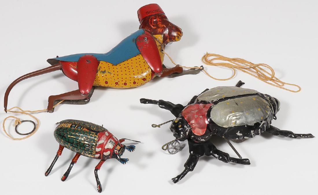 A PAIR OF GERMAN TIN WIND-UP BEETLES: A PAIR OF GERMAN TIN WIND-UP BEETLES. Comprising a good Lehmann wind-up walking flapping beetle. Together with a massive tin painted key wind clockwork beetle with impressed mark "Germany&