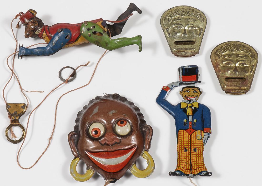 THREE TIN LITHO STRING PULL TOYS: THREE TIN LITHO STRING PULL TOYS. Comprising a googly-eyed head stamped "Made in Germany" on verso, a sad face to happy face minstrel figure, indistinguishably marked on shoes, a climbing