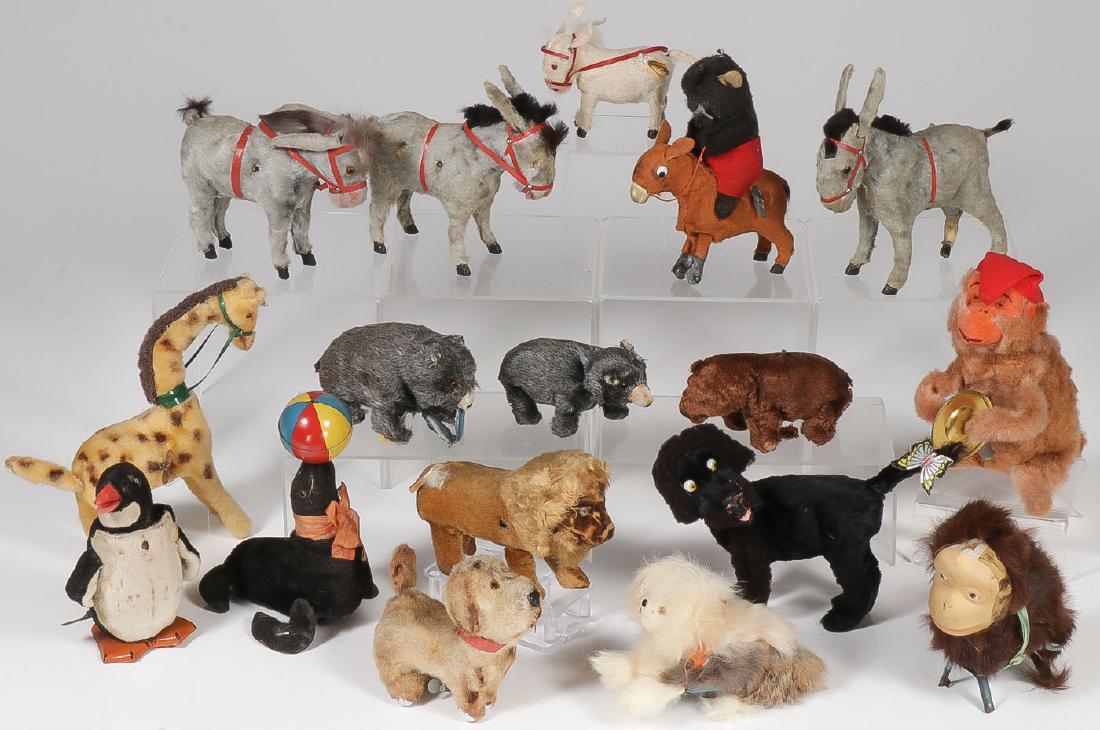 17 KEY WIND ANIMAL TOYS, C 1920-1960: 17 KEY WIND ANIMAL TOYS, C. 1920-1960. Comprising both German and Japanese fur and cloth covered animal wind-ups including a fishing bear in the original box, a wind-up giraffe, three mule