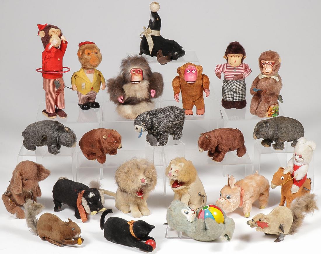 22 MECHANICAL TOY ANIMALS, C 1950: 22 MECHANICAL TOY ANIMALS, C. 1950. Comprising Occupied Japan examples including barking dog, hula hoop monkey, bunny on donkey, abominable snowman, squirrels, bears, cats with ball, monkeys, and a pi
