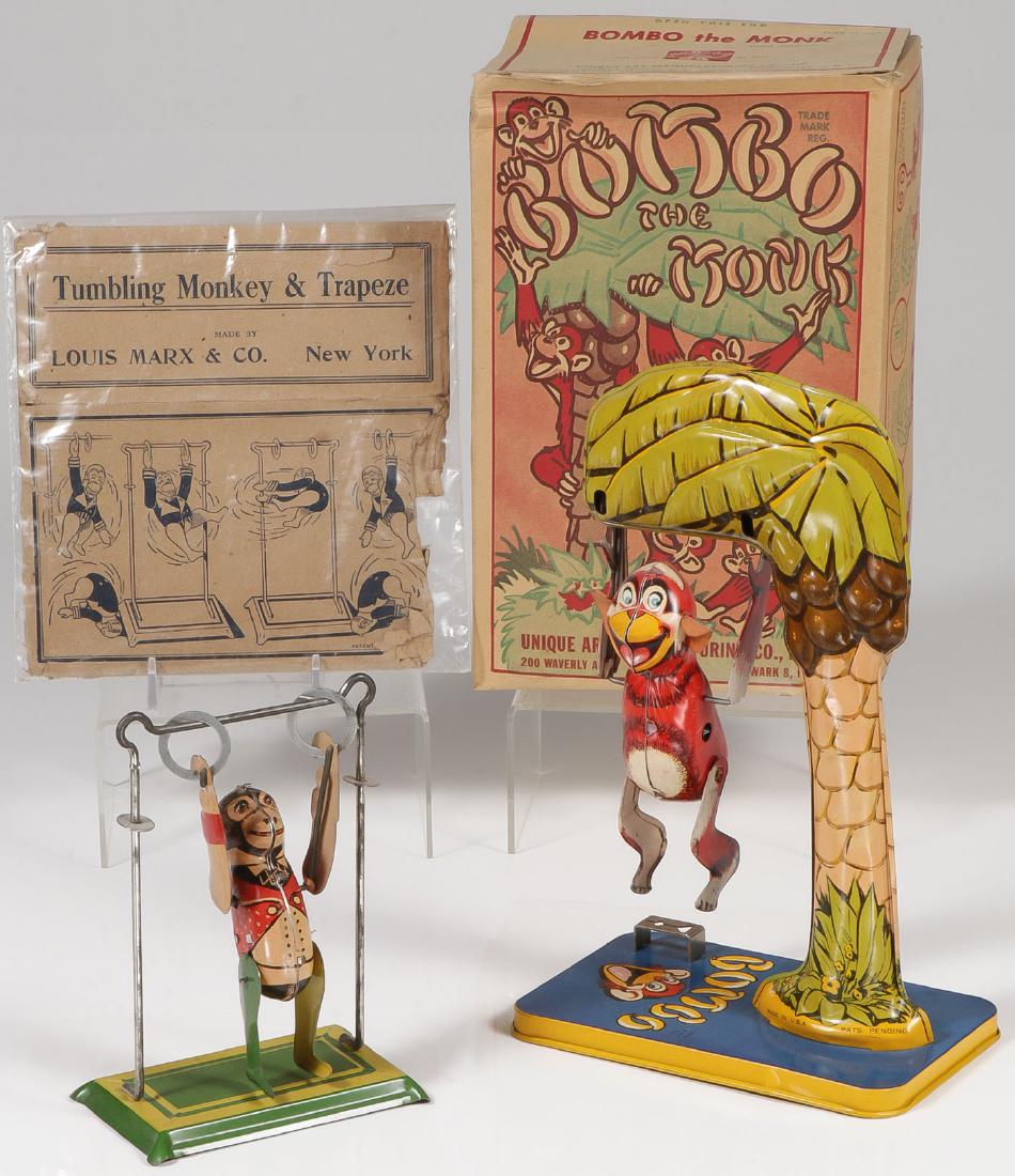 A PAIR OF TIN MONKEY TOYS: A PAIR OF TIN MONKEY TOYS. Comprising a Unique Art Bombo the Monk with original box and key, fully functional. Together with a Marx Tumbling Monkey & Trapeze with original box (approximately 80% compl