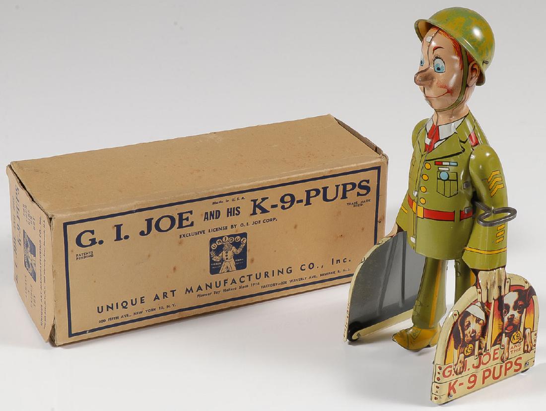 A GOOD TIN WIND-UP GI JOE & PUPS: A GOOD TIN WIND-UP GI JOE & PUPS. Comprising a fine Unique Art tin litho wind-up toy G.I Joe and His K-9 Pups. Fully functioning in very good to excellent condition and including the origi