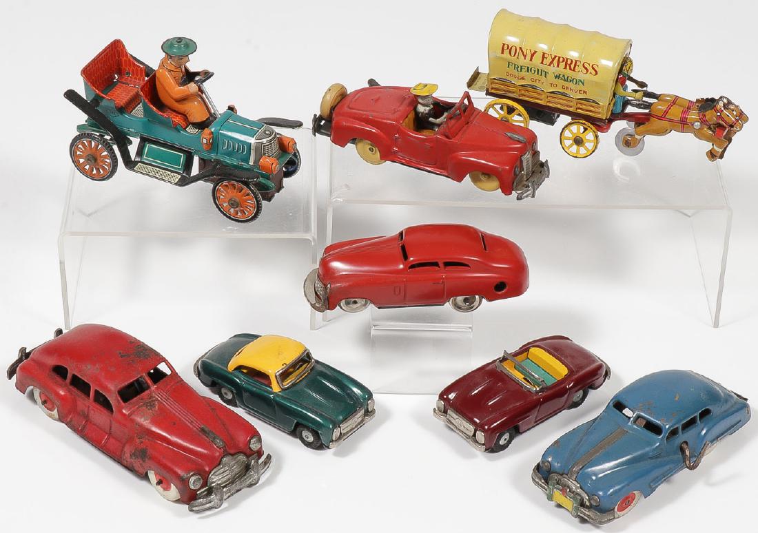 GROUP OF 8 TIN VEHICLES CIRCA 1947-1967: GROUP OF 8 TIN VEHICLES CIRCA 1947-1967. Comprising three Occupied Japan key wind cars, a key wind Schuco red coupe, two Japanese tin friction Mercedes Benz coupes, a Pony Express Freight Wagon,
