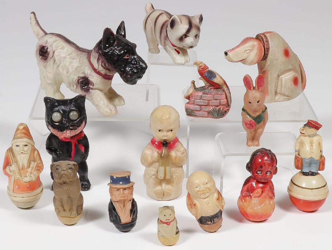 14 VINTAGE CELLULOID ROLY-POLY & FIGURES: 14 VINTAGE CELLULOID ROLY-POLY & FIGURES. Comprising six miniature celluloid roly-poly figures including a Santa Claus, an Uncle Sam, a Pineapple Girl, a Chimpanzee porter, a bulldog and a fig