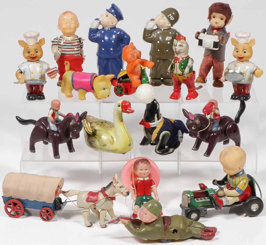 A GROUP OF 14 VINTAGE WIND-UPS: A GROUP OF 14 VINTAGE WIND-UPS. Comprising an Irwin wind-up Military Police and a wind-up Street Cop, a German tin and plastic wind-up Puss-n-Boots, a tin and vinyl wind-u