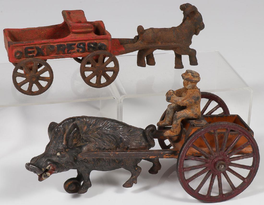 A PAIR OF CAST IRON ANIMAL CARTS: A PAIR OF CAST IRON ANIMAL CARTS. Comprising a Kenton wild boar cart in good original paint but with added driver. Together with an express goat cart without driver. Greatest measurement 8 inches. SH