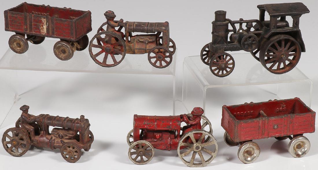 CAST IRON FARM TOYS: CAST IRON FARM TOYS. Comprising a cast iron Arcade red wagon and tractor, both with nickel wheels and in original paint, another similar set in not as good paint, an Avery cast iron tractor with broke