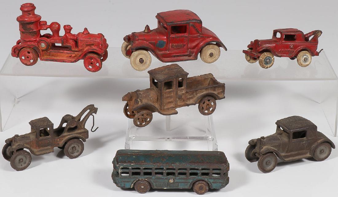SEVEN CAST IRON TOYS: SEVEN CAST IRON TOYS. Comprising an arcade Red Chief Coupe in original paint with original tires and partial label, an Arcade Roadster, an Arcade Tow-truck, a cast iron Austin Wrecker missing one 