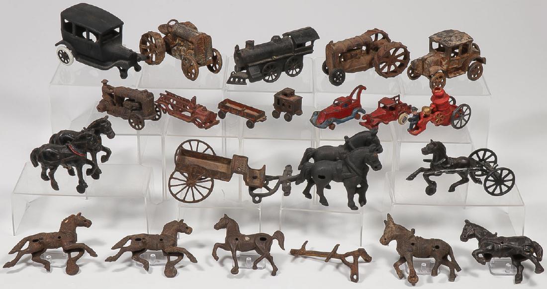 TWO DOZEN CAST IRON TOYS & PARTS: TWO DOZEN CAST IRON TOYS & PARTS. Comprising various cast iron toy parts and remnants, including tractors, steam engines, fire engines, coupes, wreckers, horses, wagons, hitches, and various drivers. 