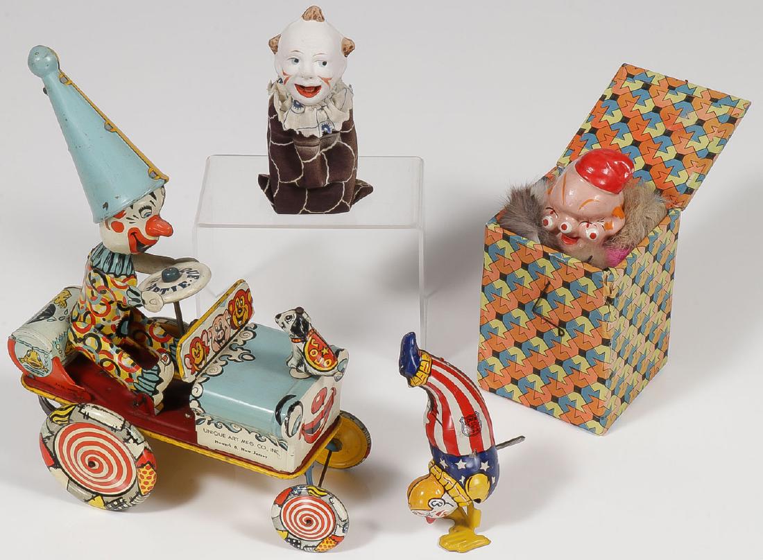 GROUP OF VINTAGE CLOWN TOYS, C 1900-1950: GROUP OF VINTAGE CLOWN TOYS, C. 1900-1950. Comprising a good functioning Unique Art tin wind-up Artie the Clown car, a Chein tin wind-up clown, a German clown squeeze/squeak toy (tongue s