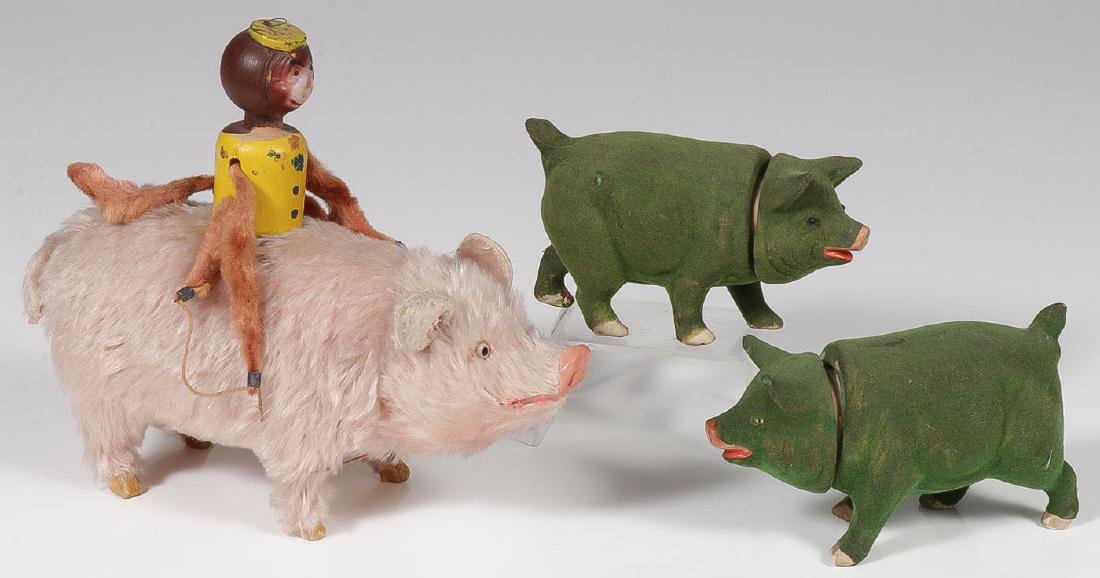 THREE GREAT GERMAN PIG CANDY CONTAINERS: THREE GREAT GERMAN PIG CANDY CONTAINERS. Comprising a large mohair pig with papier-mache body and face with glass eyes and wooden legs and with possibly added monkey rider, head opens to reveal ca