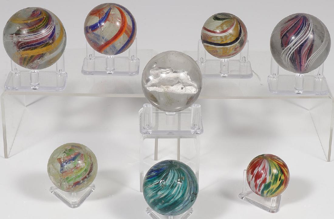 EIGHT LARGE VINTAGE MARBLES: EIGHT LARGE VINTAGE MARBLES. Comprising two large swirls (2 inches), a sulfide with rabbit (1.75 inches), a 1.5 inches onion skin, a 1.2 inches onion skin, and three other swirls. SHIPPING NOTICE:
