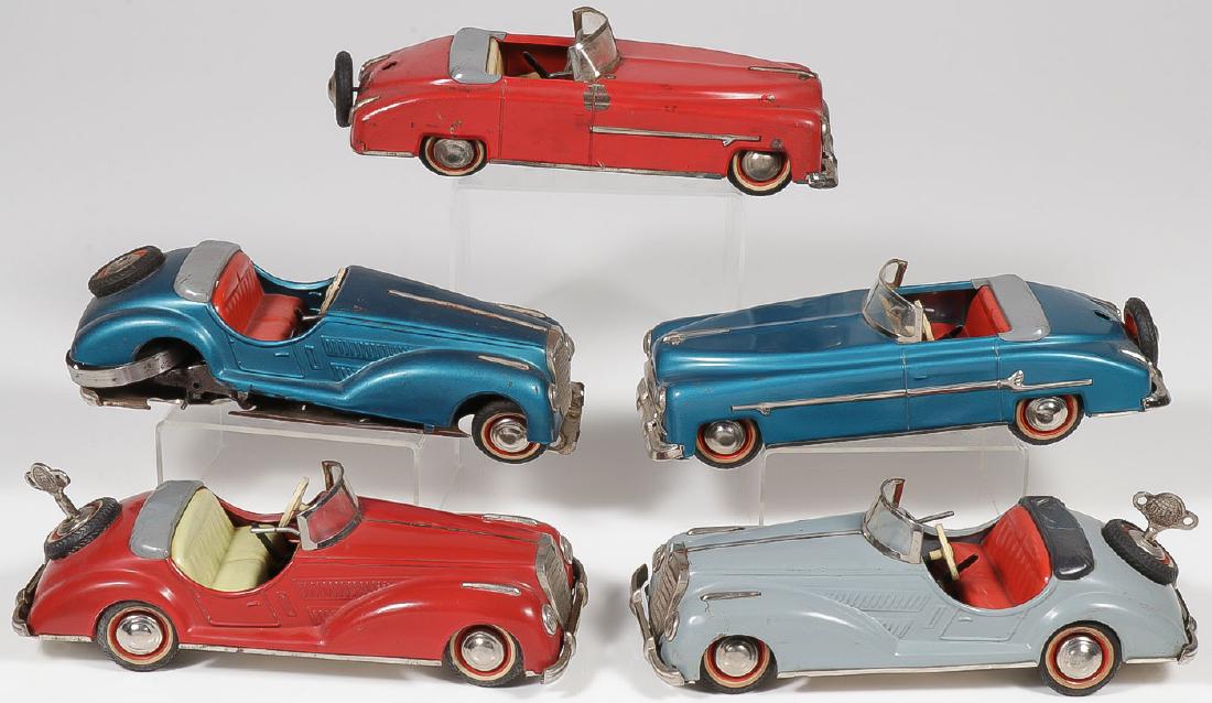 FIVE DISTLER US ZONE KEY WIND CARS: FIVE DISTLER U.S. ZONE KEY WIND CARS. Comprising three Mercedes key wind clockwork convertibles in red, grey and blue. Both the red and grey specimens have keys, take a wind, and run well, however, ea