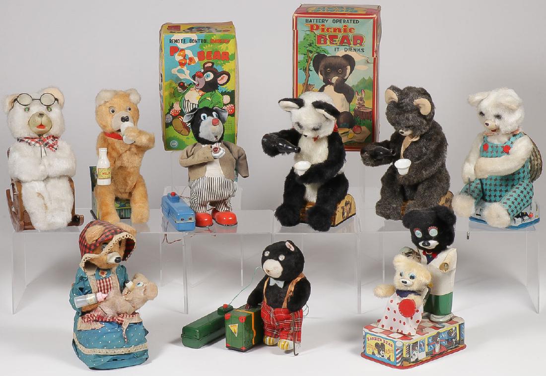 9 VINTAGE BATTERY POWERED TOYS: 9 VINTAGE BATTERY POWERED TOYS. Comprising a knitting grandma bear in rocker, a baby bear drinking milk, a San Pa Pa pipe smoking bear in box, an Alps picnic drinking bear with box, another similar p