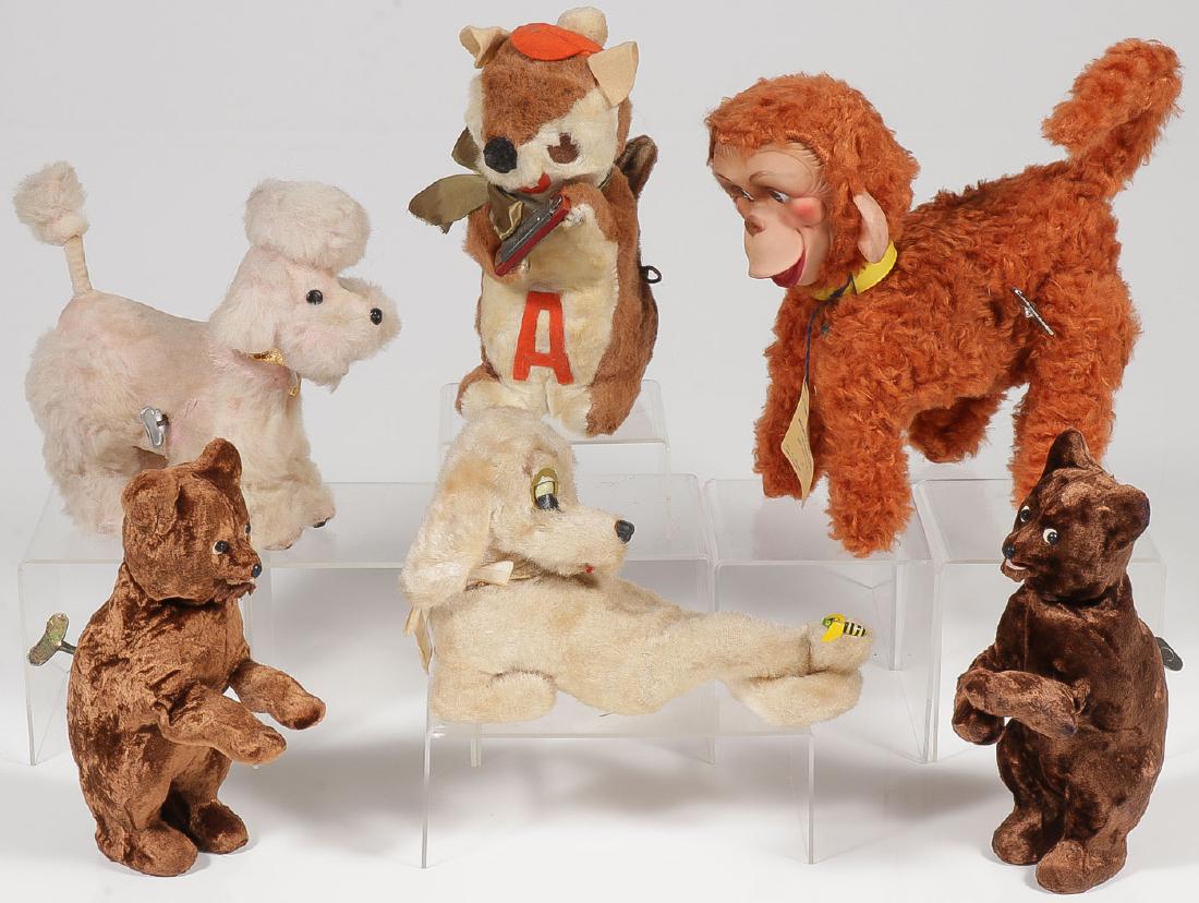 SIX VINTAGE WIND-UP ANIMAL TOYS: SIX VINTAGE WIND-UP ANIMAL TOYS. Comprising a pink poodle, Alvin the Chipmunk, a Nutcraft Bombo the Wonder Ape, two stand-up key wind bears, and a reclining dog with bumble bee on foot. Great