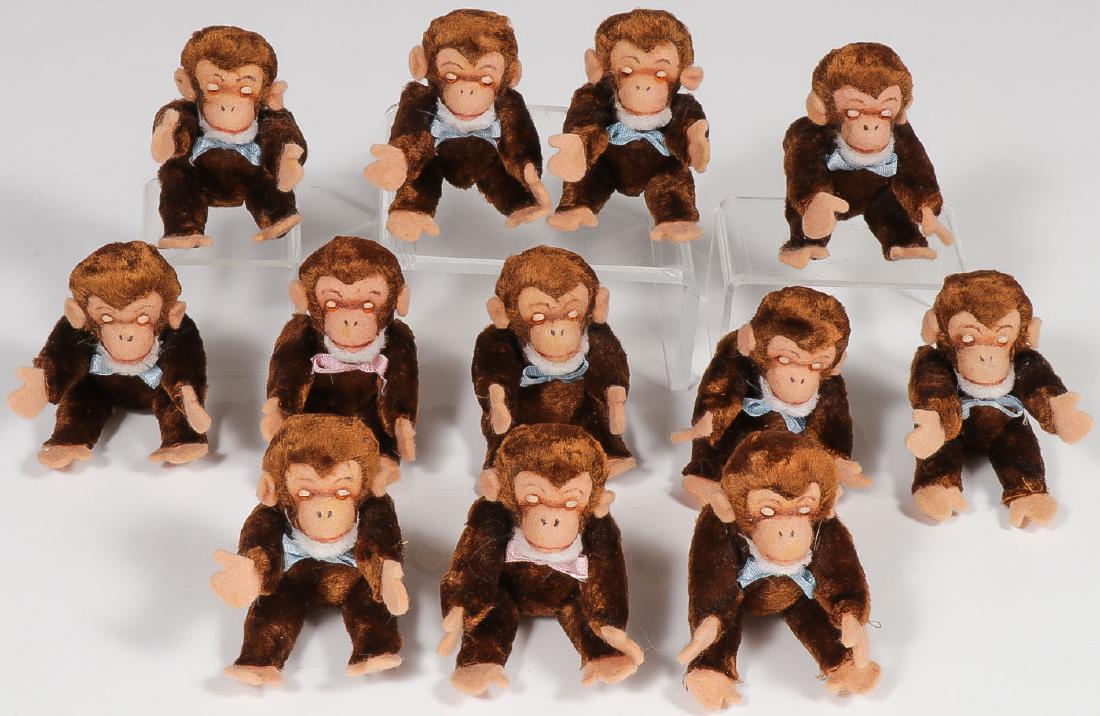 A DOZEN MONKEYS: A DOZEN MONKEYS. Comprising 12 mint cloth and felt jointed monkeys with glass eyes, and contained in their original box. Probably Germany circa 1955. Each figure 4 inches. Provenance: From the lifet
