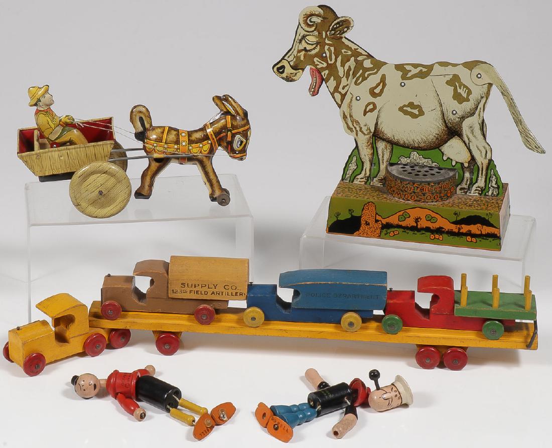 MIXED LOT OF FOUR VINTAGE TOYS: MIXED LOT OF FOUR VINTAGE TOYS. Comprising a Popeye and Olive Oyl wooden string figures by K.F.S. each approximately 5 inches, a Marx tin litho wind-up donkey and cart (works), a tin litho moo cow
