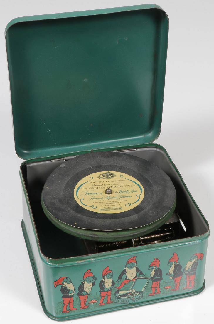 AN INTERESTING LOT OF CHILDREN’S THINGS: AN INTERESTING LOT OF CHILDREN'S THINGS. Comprising a Bing Pigmyphone miniature lithographed tin record player missing needle and horn, a Mother Hubbard toy bank in the shape of a book, a Donald