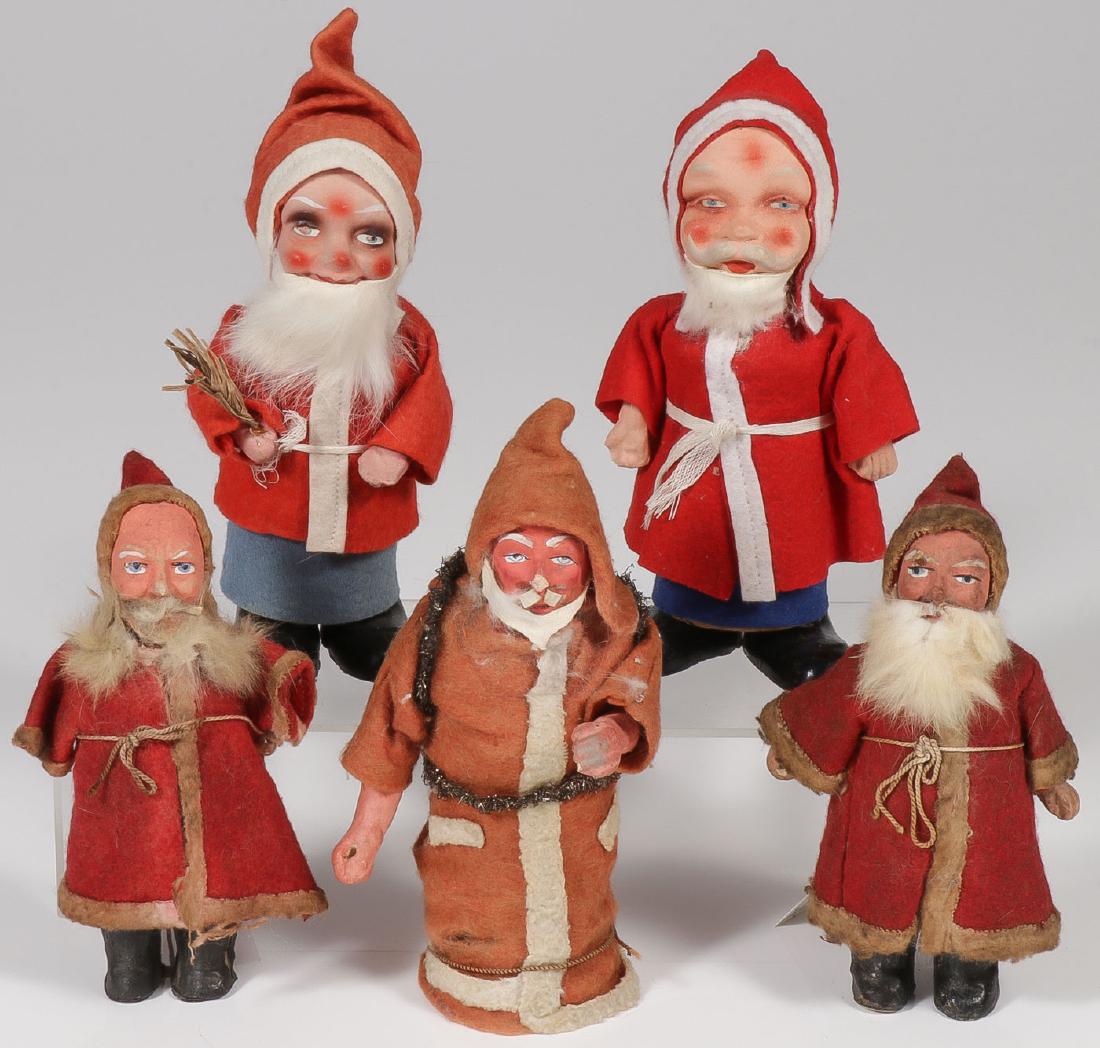 FIVE GERMAN SANTAS, INCLUDING WIND-UPS: FIVE GERMAN SANTAS, INCLUDING WIND-UPS. Comprising five German papier-mache and felt Santa Claus or Father Christmas figures. The two largest being candy containers, one with original "Mad