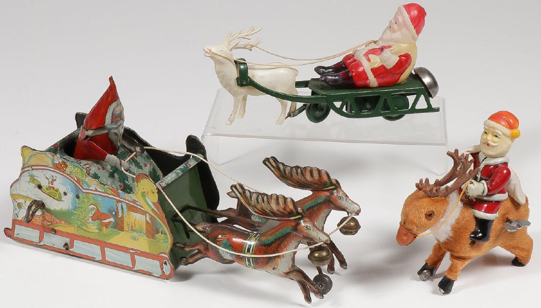 THREE WIND-UP SANTAS: THREE WIND-UP SANTAS. Comprising a great Strauss tin litho wind-up "Santee Claus" with sleigh and reindeers, good sound condition, fully functional. Together with a tin and celluloid w